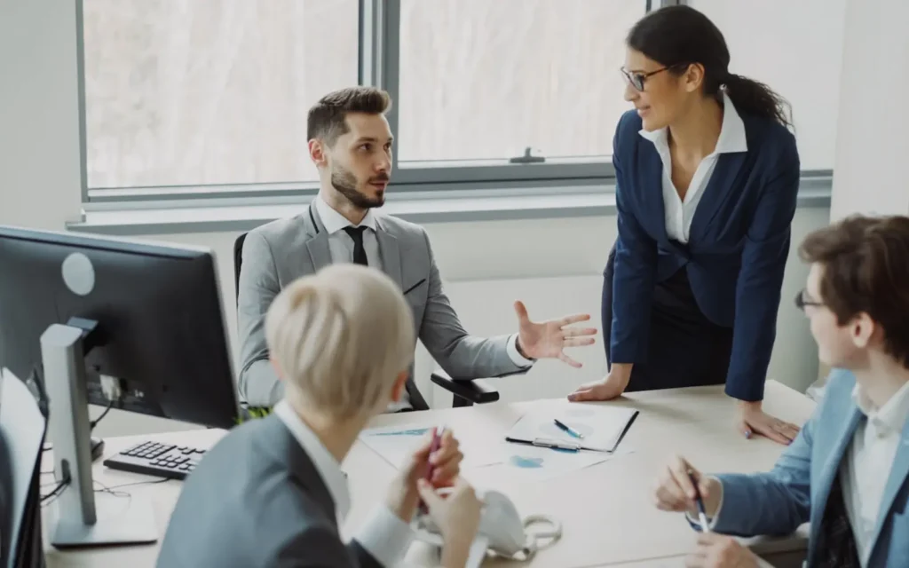 Professionals collaborating around a table during a workplace meeting