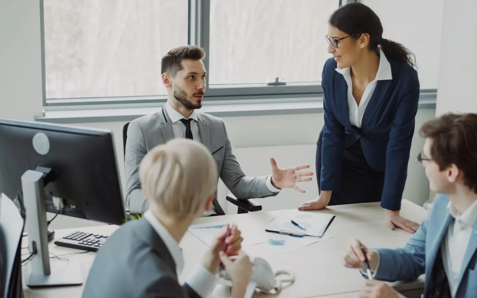 Professionals collaborating around a table during a workplace meeting